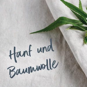Grober Hanf-Baumwollstoff ein Hanfblatt und dem Schriftzug „Hanf und Baumwolle“ – Symbol für nachhaltige Textilien.