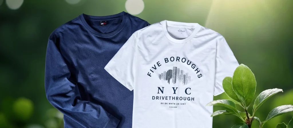 Dunkelblauer Pullover und weißes T-Shirt auf grünem Hintergrund mit Pflanzen – Symbol für nachhaltige Mode.