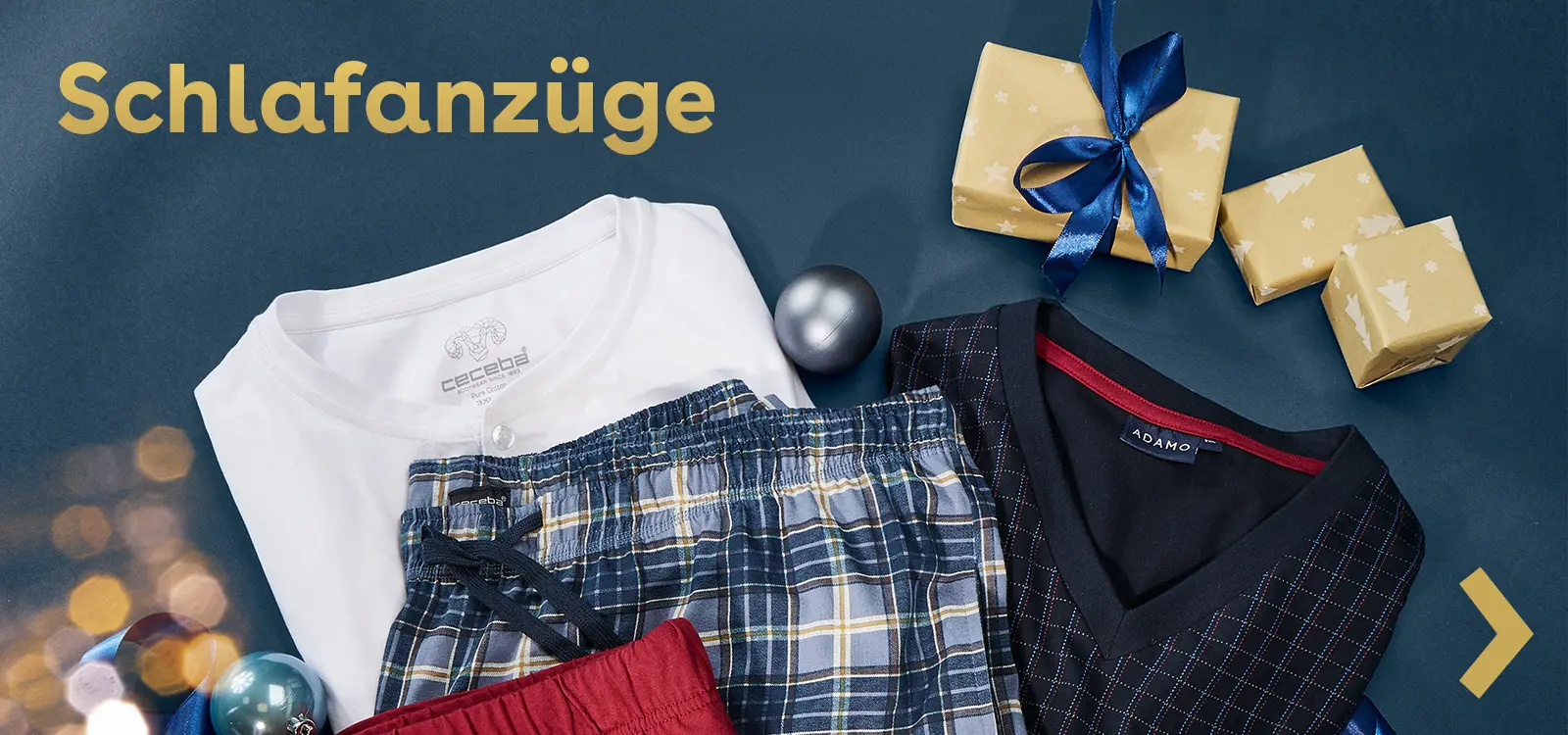 Schlafanzugset mit weißem Shirt und karierter Hose auf blauem Hintergrund mit Weihnachtsakzenten.